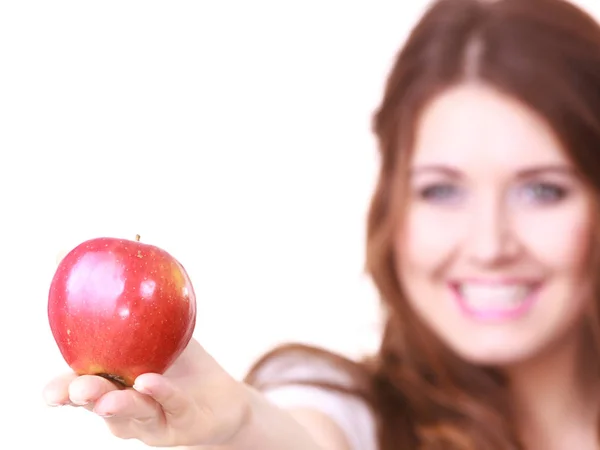 Woman holds red apple, focus on fruit — Stock Photo, Image