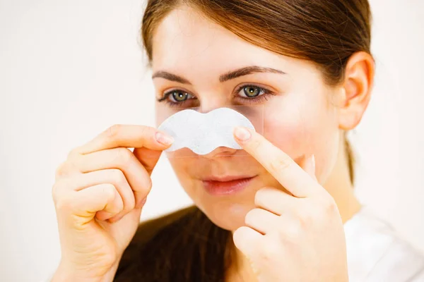 Mujer que aplica tiras de poro en la nariz —  Fotos de Stock