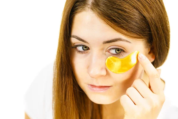 Woman with gold patches under eyes — Stock Photo, Image