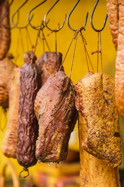 Smoked sausages meat hanging in smokehouse — Stock Photo, Image