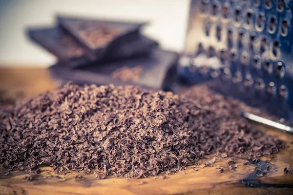 Grater and grated chocolate closeup — Stock Photo, Image