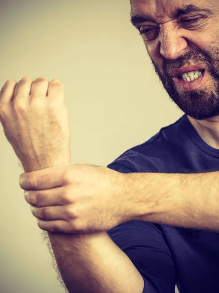 Man feeling pain in wrist — Stock Photo, Image