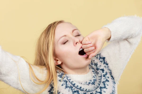 Sleepy yawning teenage woman in jumper — Stock Photo, Image