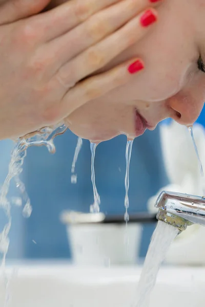 Mujer lavándose la cara en el baño. Higiene . — Foto de Stock