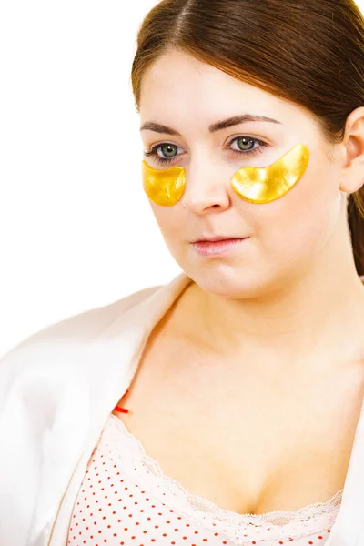 Woman with gold patches under eyes — Stock Photo, Image