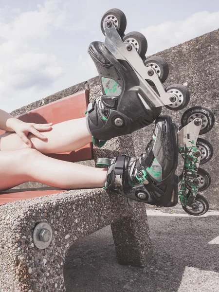 Mujer en el banco con patines —  Fotos de Stock