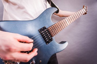 Close up of man playing on electric guitar clipart