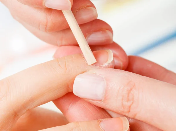 Preparing nails before manicure, pushing back cuticles — Stock Photo, Image