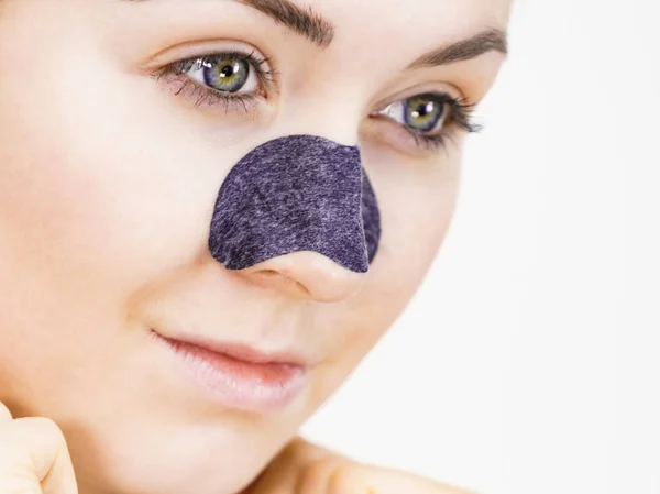 Woman applying pore strips on nose — Stock Photo, Image