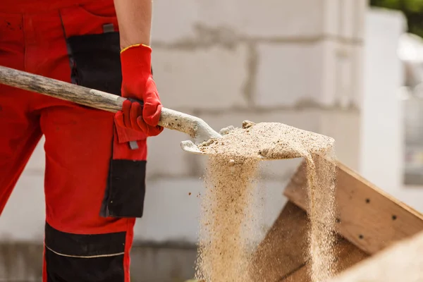 Person using shovel on construction site