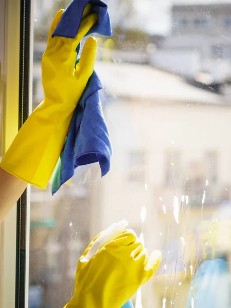 Gloved hand cleaning window rag and spray — Stock Photo, Image