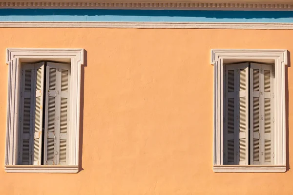 Old window shutters on orange home — Stock Photo, Image