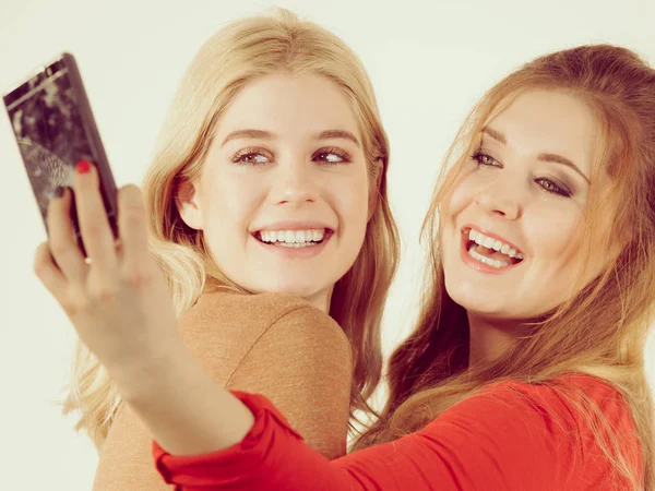 Две женщины делают селфи с помощью смартфона — стоковое фото
