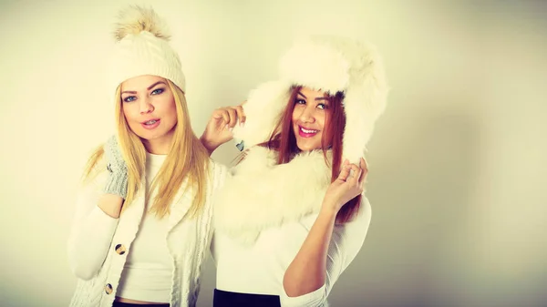Two girls in warm winter clothing having fun. — Stock Photo, Image