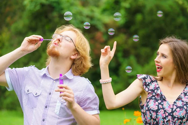 Пара дующих мыльных пузырей, веселящихся — стоковое фото