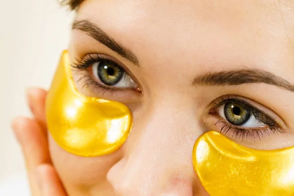 Woman with gold patches under eyes — Stock Photo, Image