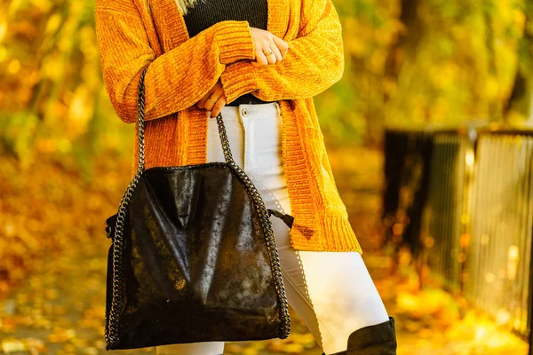 Woman wearing orange autumn cardigan outdoor