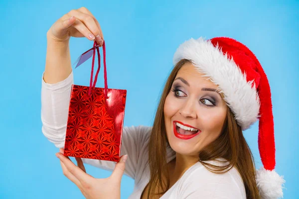 Happy Christmas woman holds gift bag Royalty Free Stock Photos