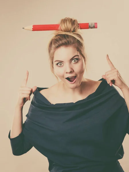 Shocked blonde woman having big pencil in hair — Stock Photo, Image