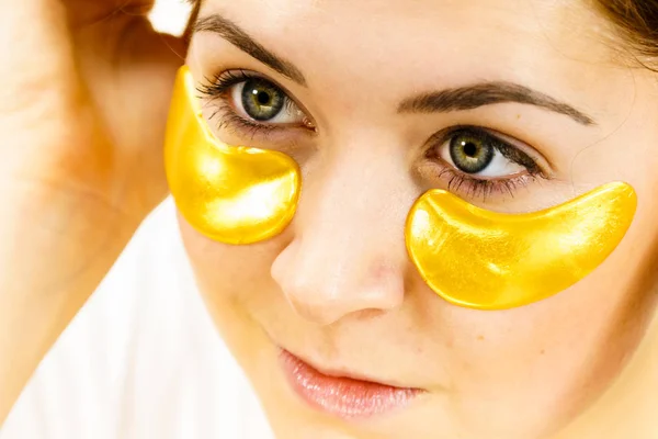 Woman with gold patches under eyes — Stock Photo, Image