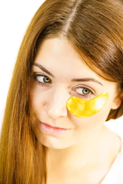 Woman with gold patches under eyes — Stock Photo, Image