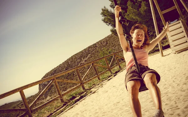 Adult woman having fun on zipline — Stock Photo, Image