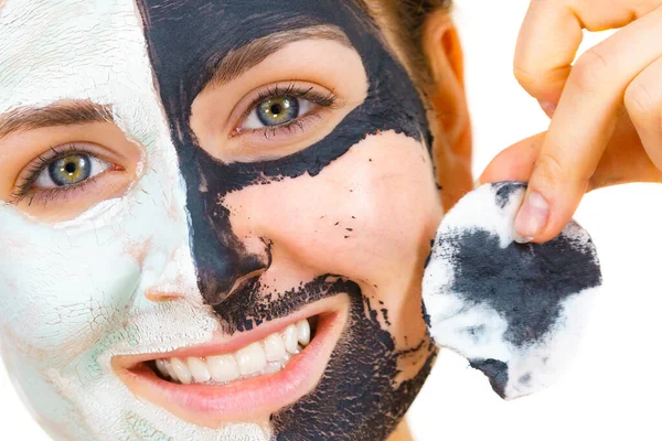 Girl remove black white mud mask from face — Stock Photo, Image