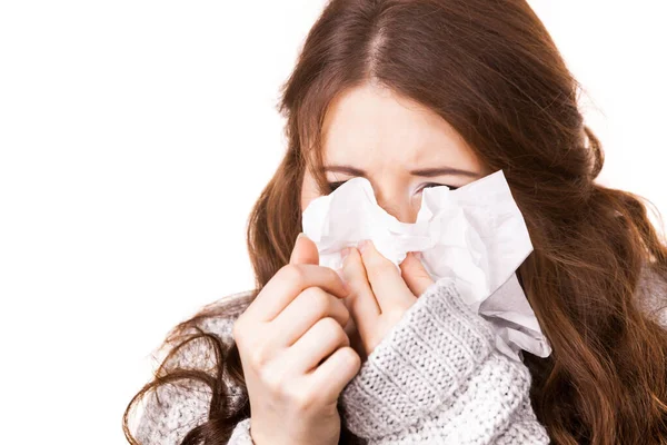 Sick freezing woman sneezing in tissue — Stock Photo, Image