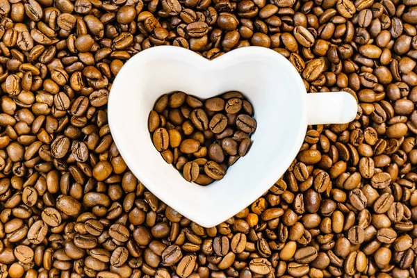 Copa en forma de corazón sobre fondo de café —  Fotos de Stock