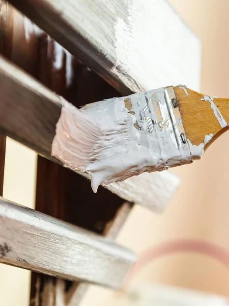 Person renovating wooden hanger — Stock Photo, Image