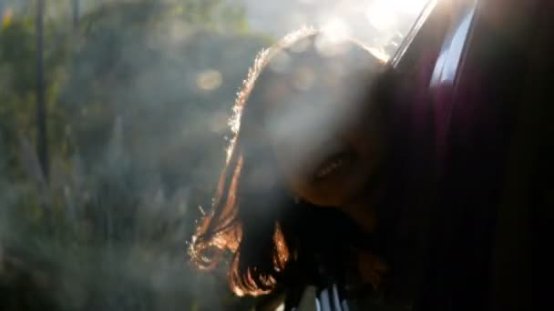少女は太陽の光で車から頭を弾け — ストック動画