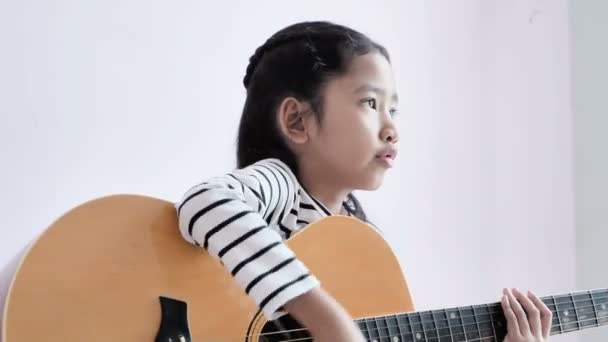 Girl Wearing Black White Striped Dress Playing Guitar Singing — Stock Video