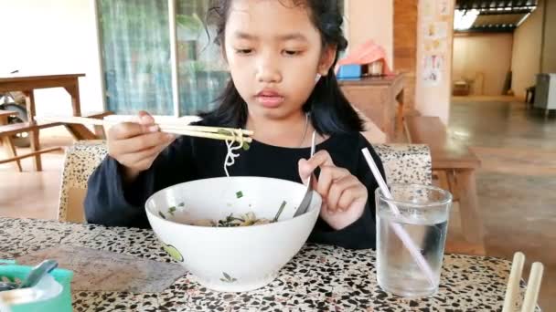 Asian Little Girl Eating Noodles Delicious — Stock Video
