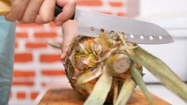 Kesme tahtasında ananas soyma