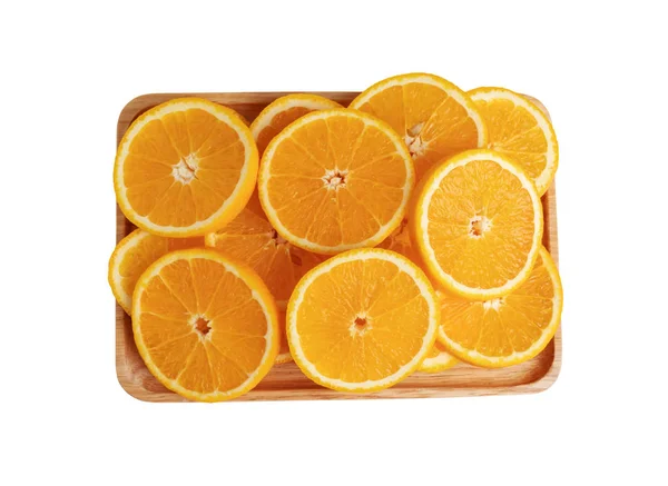 Frutti arancioni tagliati a pezzi sul piatto di legno con isolat — Foto Stock