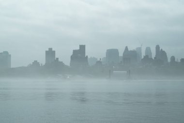 Rainy Manhattan, business district of New York City, heavy fog. clipart