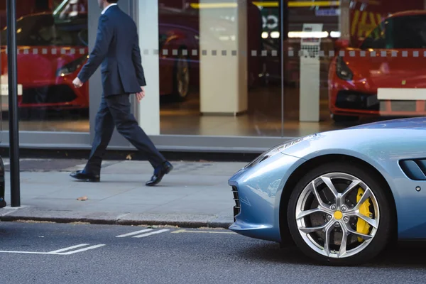 Man in suit walks near car