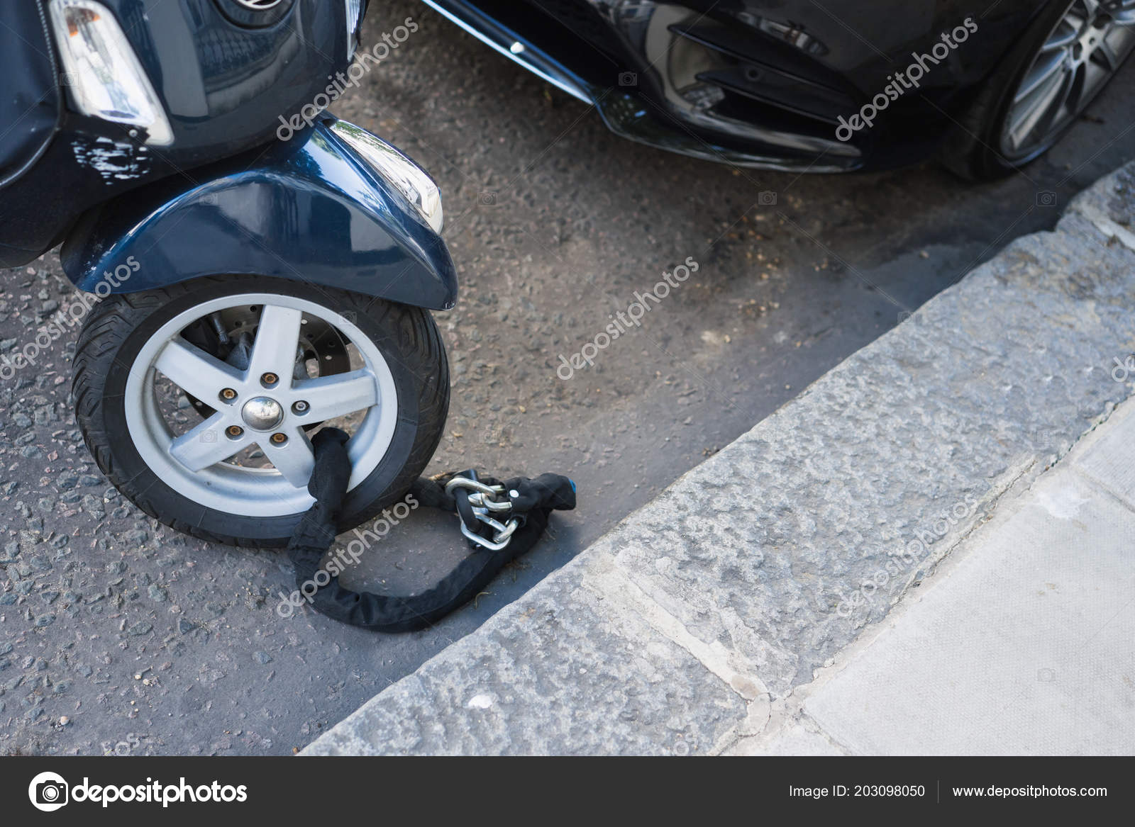 Moped wheel on lock Stock Photo by ©tarafoto 203098050