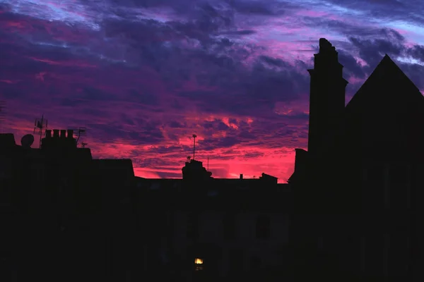 Рожевий захід сонця за будинками — стокове фото