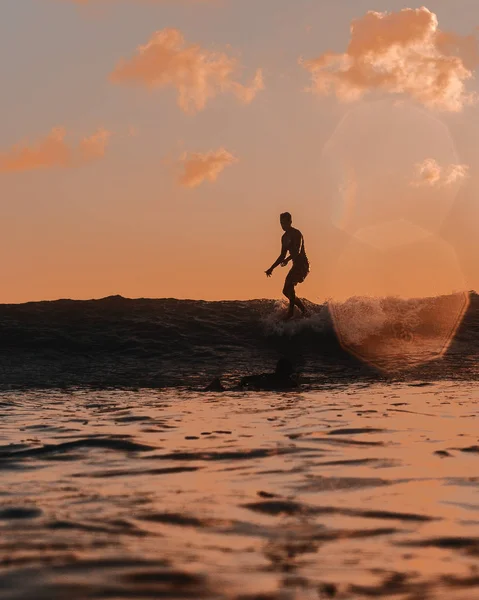 Male surfer on the board on waves