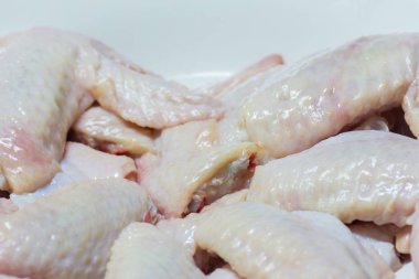 Taze çiğ tavuk kanatları üzerinde beyaz tabak, yemek pişirmek için hazır olsun.