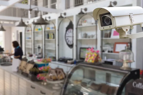 The CCTV Security Camera operating in the coffee shop blur background.