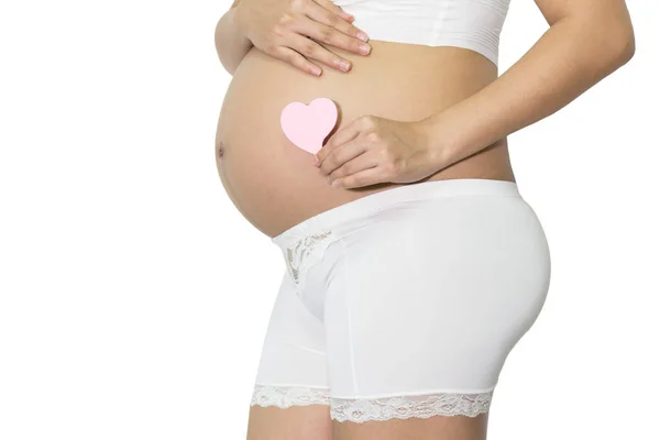 Gravid Kvinna Hand Innehav Tom Rosa Papper Obs Hjärta Magen — Stockfoto