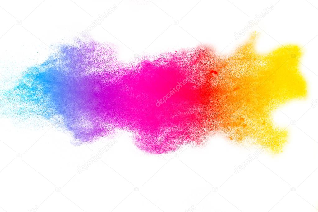 Multi color powder explosion on white background. Launched colorful dust particles splashing. Red yellow blue powder splatter.