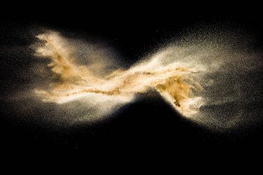 Golden sand explosion isolated on black background. Abstract sand cloud. Golden colored sand splash against dark background. Yellow sand fly wave in the air. clipart