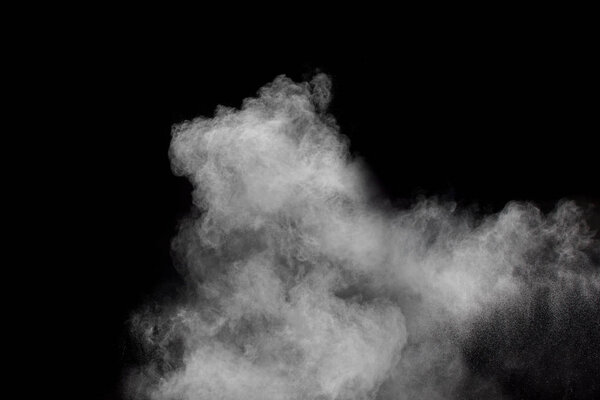 White talcume powder explosion on black background. White dust splashing. White smoke.