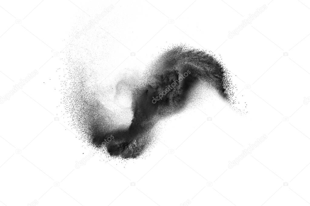 Black powder explosion on white background.Black dust particles splash.Painted Holi powder festival.
