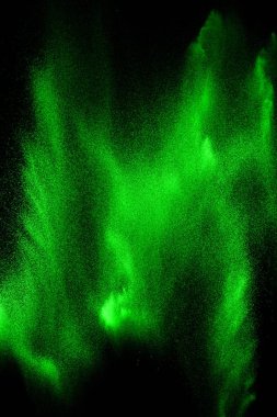 Yeşil parçacıklar siyah arka planda patlama. Renk toz sıçraması