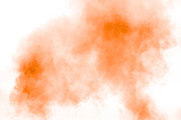 Abstract orange powder explosion on  white background. Freeze motion of orange dust splash.