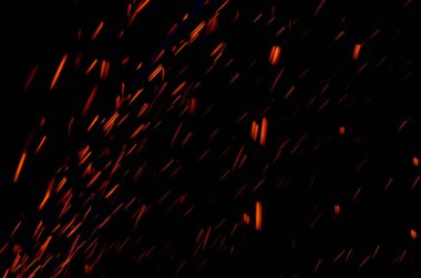 Soyut hareket parçacıkların ışık arka planını bulanıklaştırır. Kırmızı kıvılcımlar.